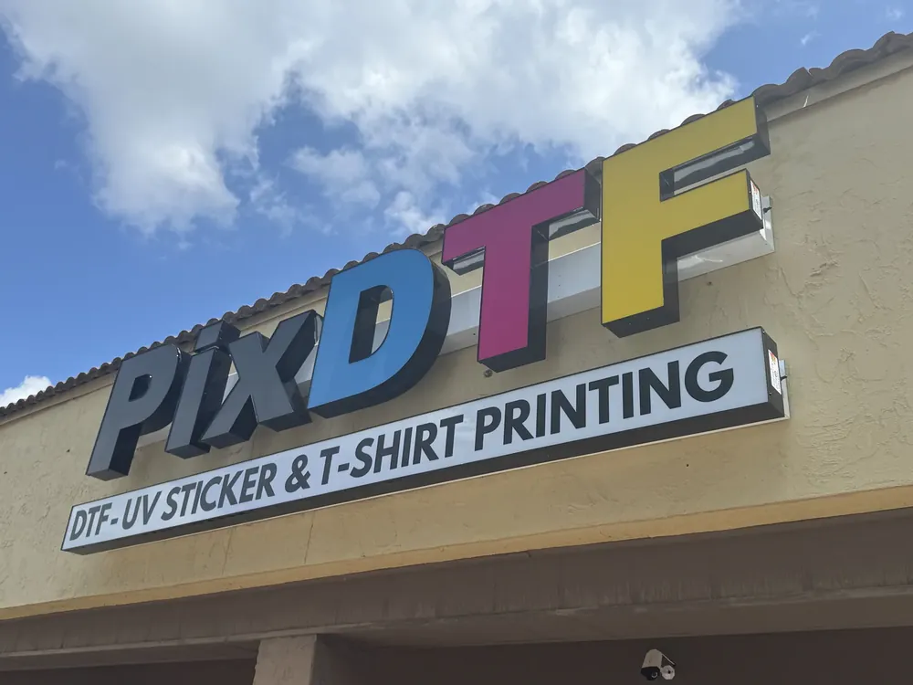 Illuminated channel letters on a printing shop storefront
