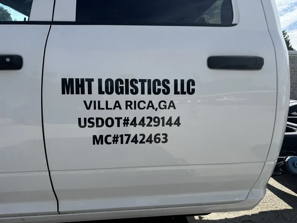 US DOT and MC numbers lettered on a truck door